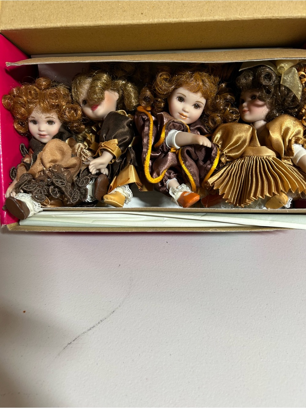 Charisma Porcelain Doll Quartet in Gold and Brown